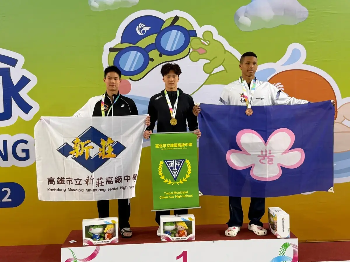 115年全中運游泳賽場中，學生選手在終點觸壁，場邊可見電子計時板