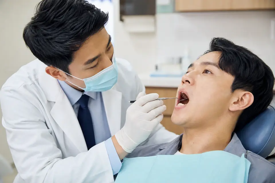 牙醫師檢查民眾口腔黏膜示意
