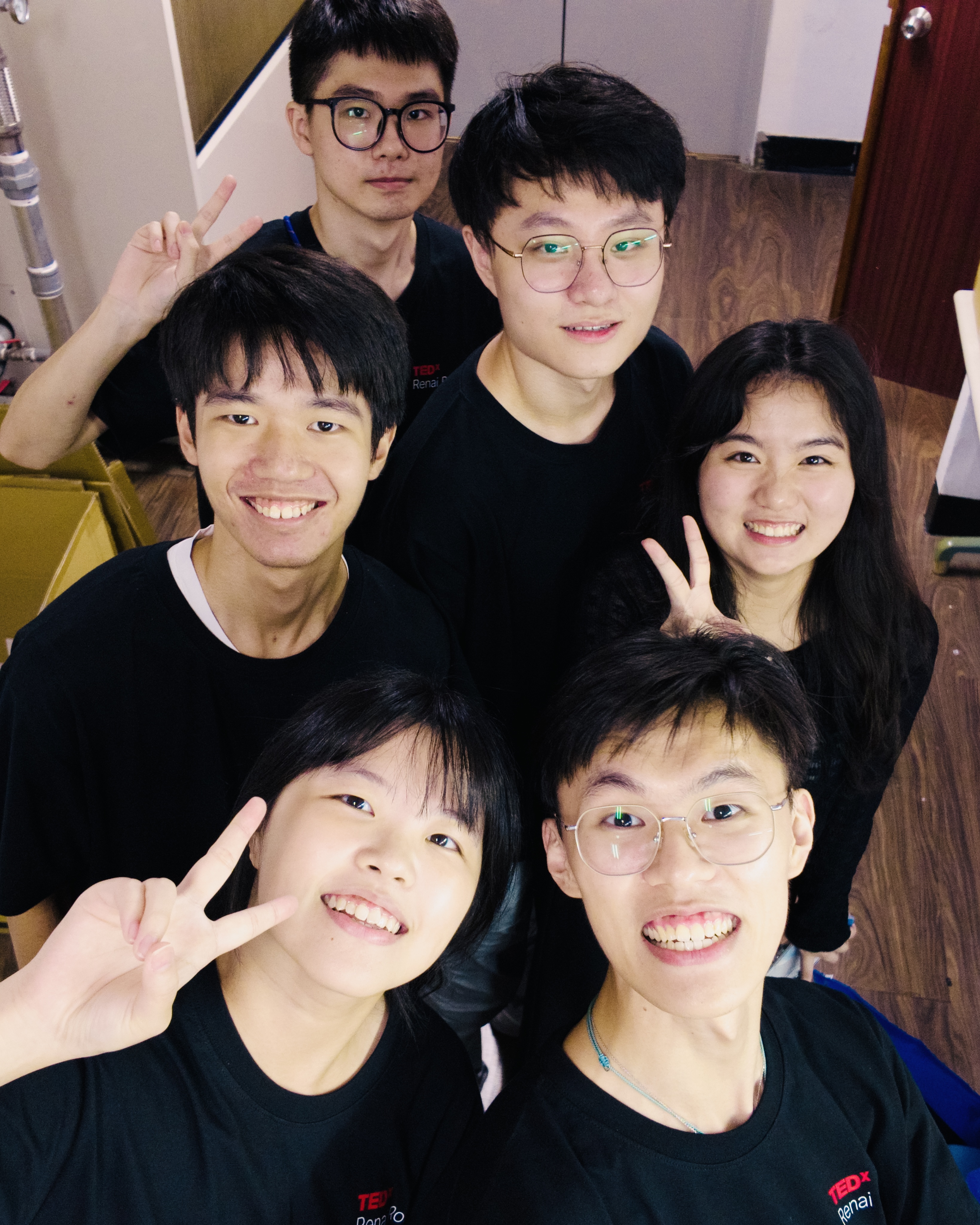 TEDxRenaiRoad志工們在後台合照,身穿黑色志工T恤比手勢